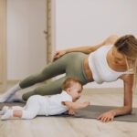 Mother exercises with her baby