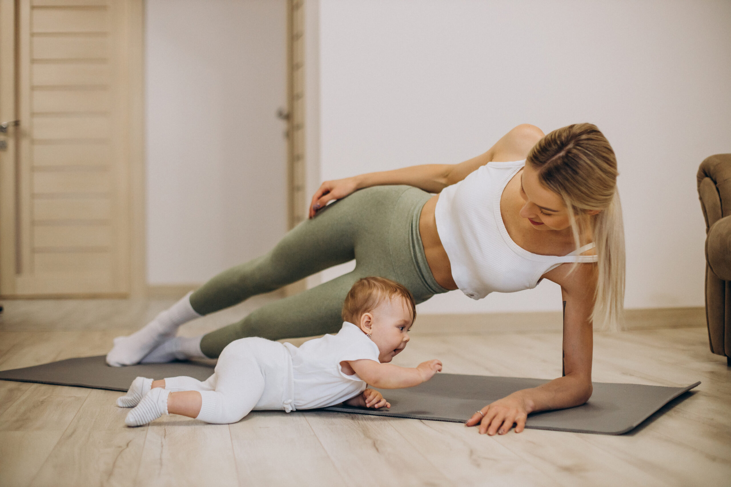 Mother exercises with her baby